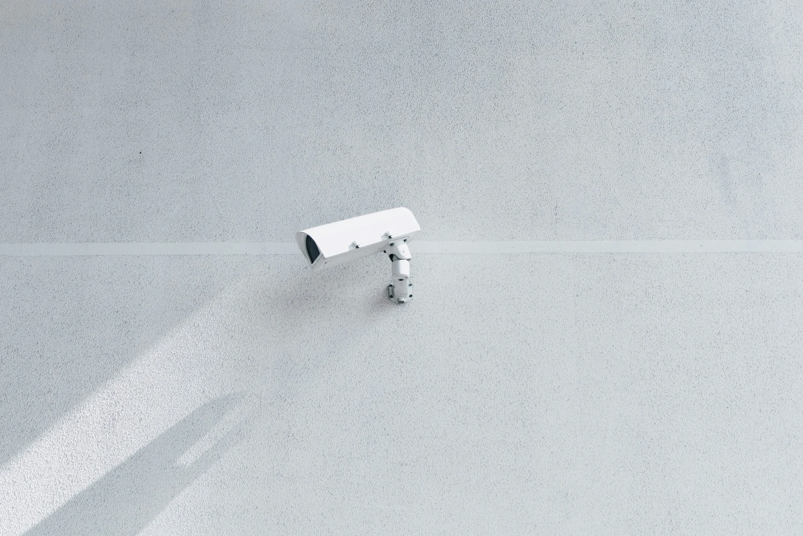 security camera near a ceiling pointing left